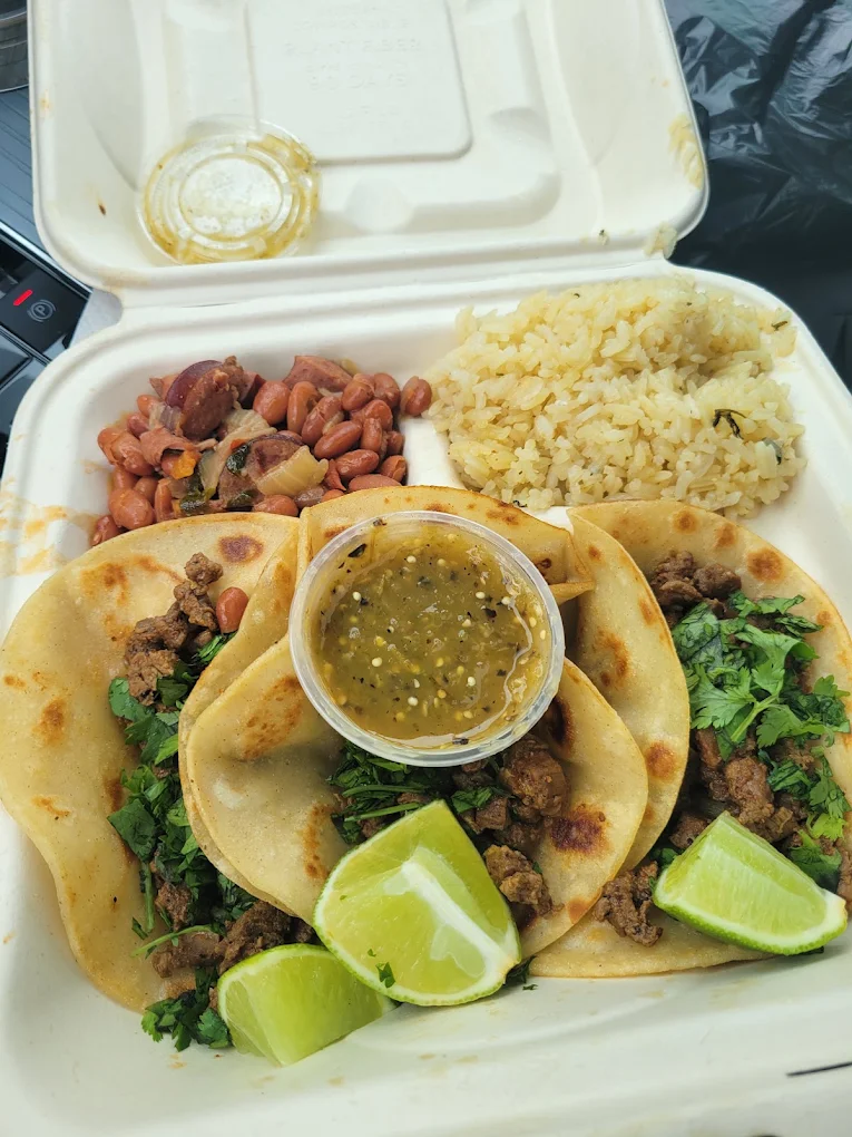 Street taco plate with rice, beans, lime and green salsa from Fronteras Taqueria